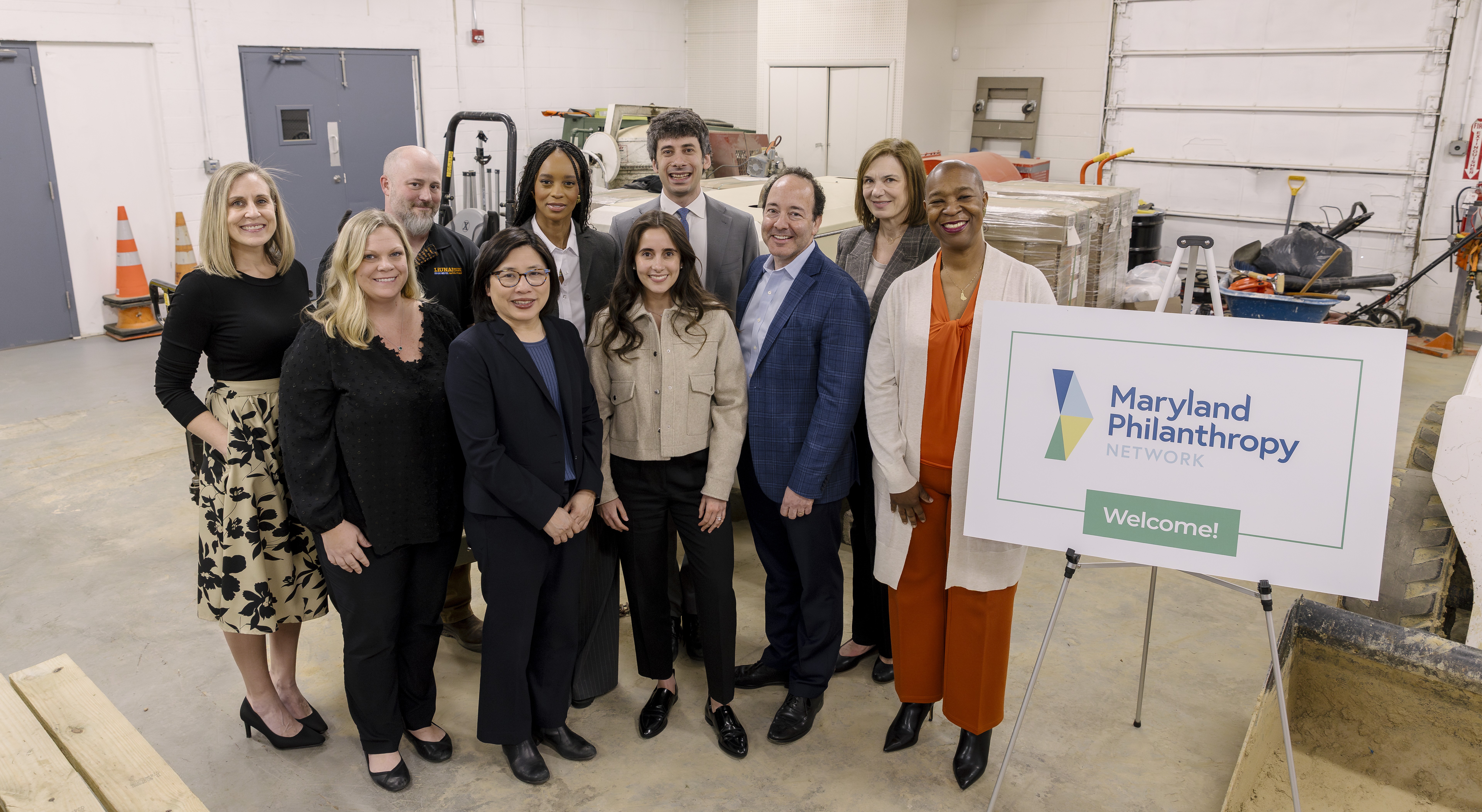Partners pose for a photo with an MPN logo sign at the JPMC Grant Launch Event in March 2025.