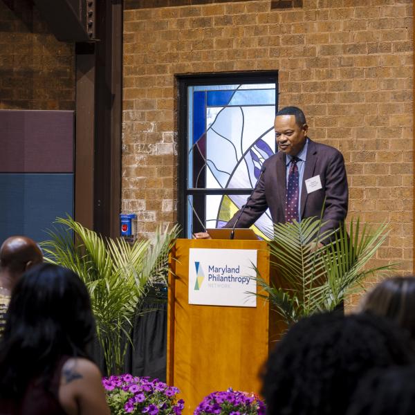 Talib Horne speaks at the podium during the 2025 Annual Gathering.