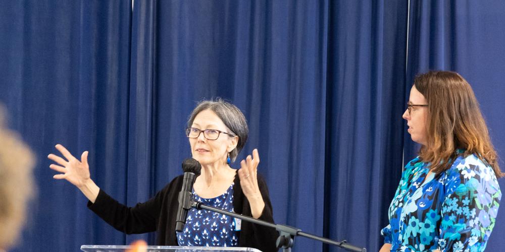 Secretary Carmel Roques speaks to the crowd from the podium at the 2026 Maryland Aging Innovations Summit