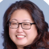 Headshot of an Asian woman with dark hair and dark rimmed rectangular glasses.